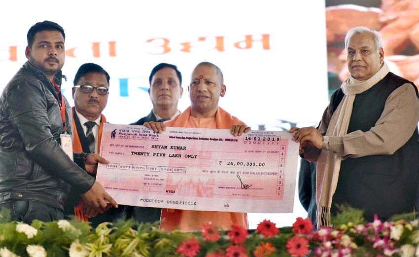 UPCM हस्तशिल्पियों/उद्यमियों को चेक प्रदान करते हुए