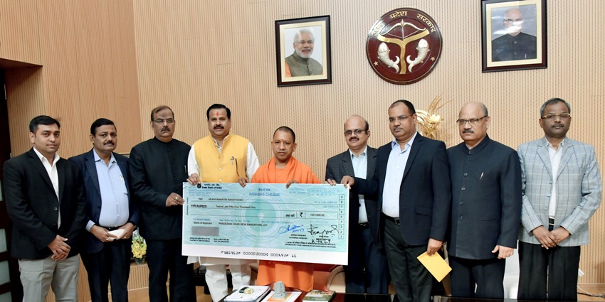 UPCM को प्रादेशिक विकास सेवा संगठन के प्रतिनिधिमण्डल चेक भेंट करते हुए